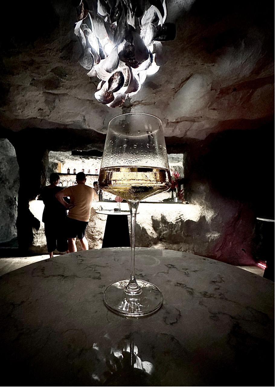 Rockfish Cliffside bar with oyster shell chandelier and stone walls