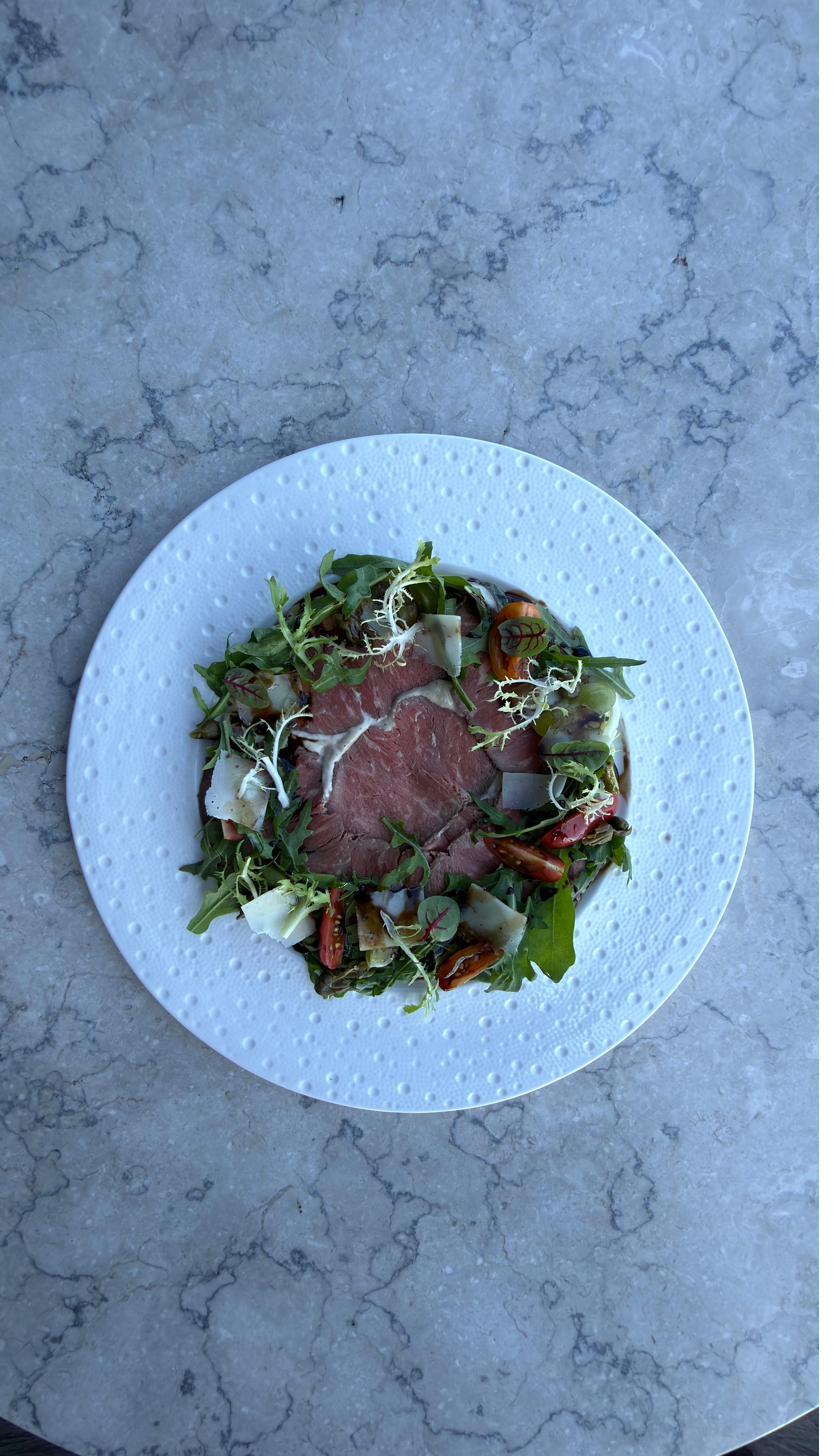 Beef carpaccio with rocket and tomato at Rockfish Cliffside