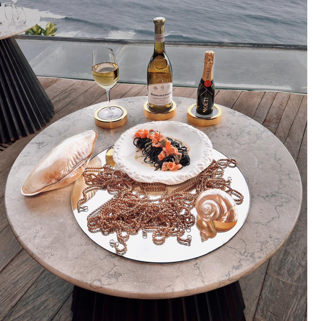 Squid ink linguine with salmon and glass balcony view at Rockfish Cliffside